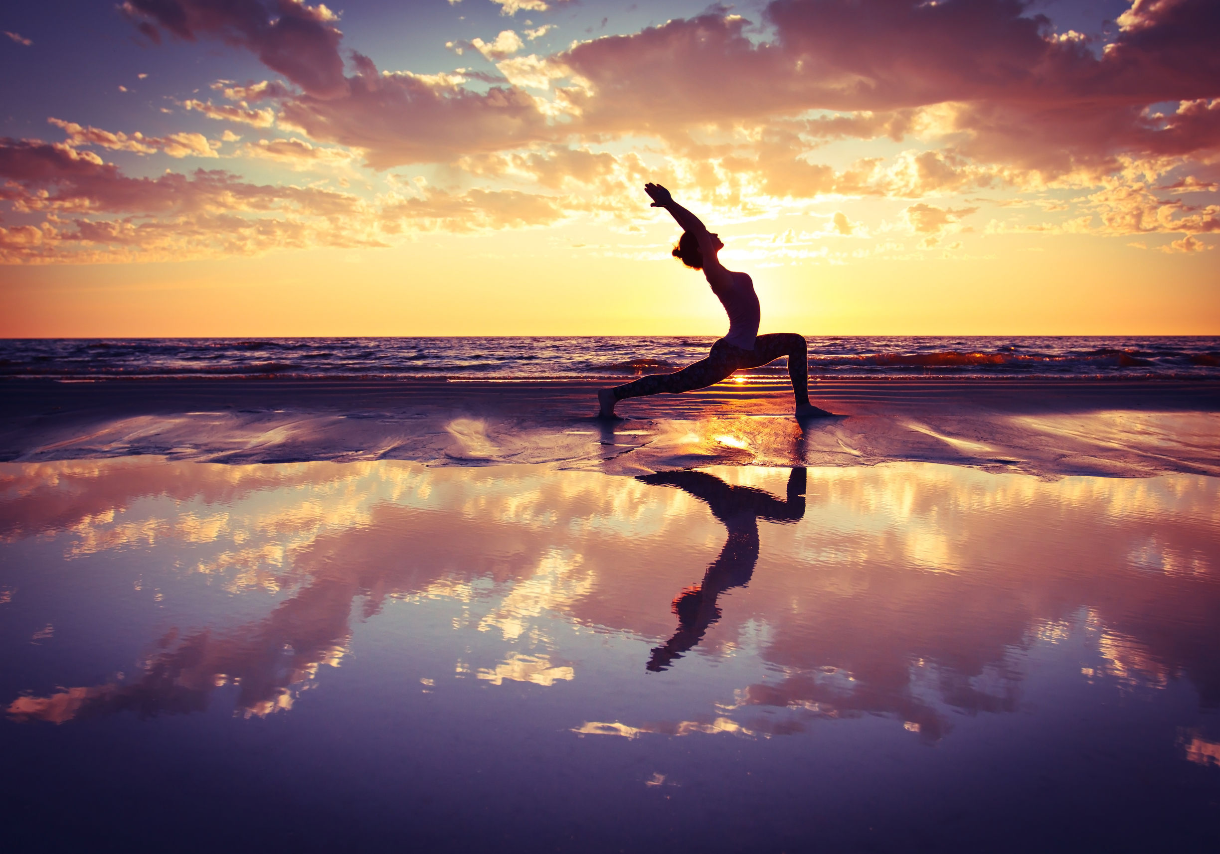 44246231 – silhouette of woman practicing yoga on the beach at sunset